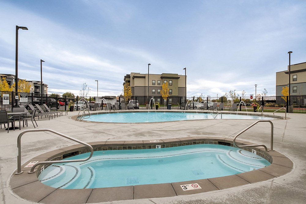 hot tub and pool at the enclave at woodbridge apartments in sugar land, tx