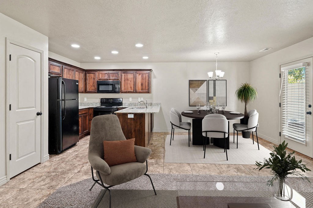 a living room and kitchen with a table and chairs