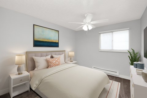 A bedroom with a large bed, a ceiling fan, and a painting on the wall.