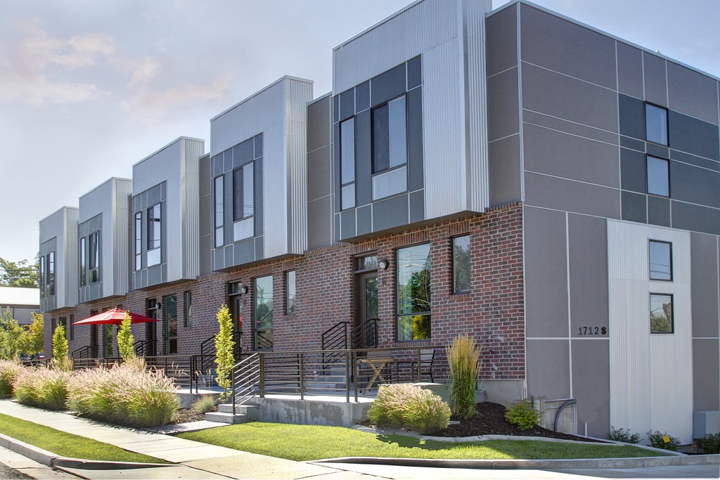 a row of apartments with a sidewalk in front of them at BlueKoi Townhomes for rent in Salt Lake City, UT