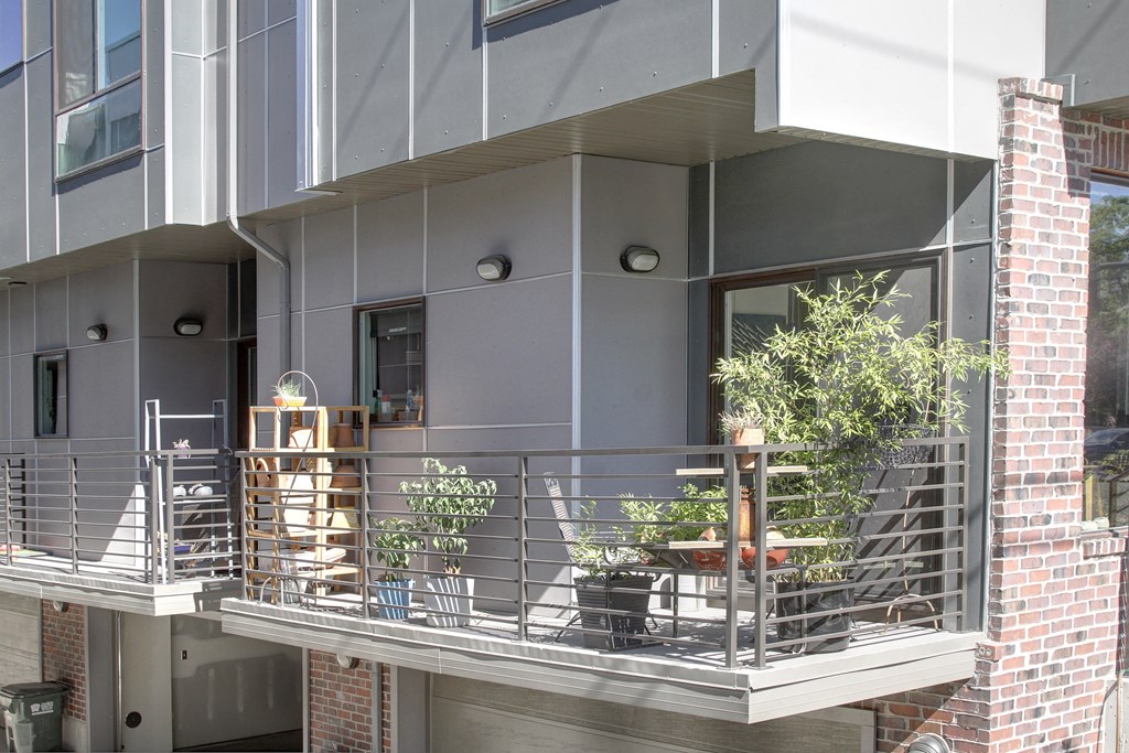 a balcony with a metal railing and plants on it at BlueKoi Townhomes for rent in Salt Lake City, UT