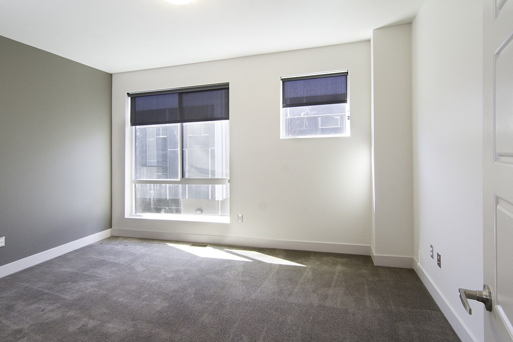 an empty room with a window and a door at BlueKoi Townhomes for rent in Salt Lake City, UT