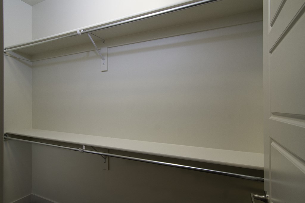 an empty closet with a white wall and a sliding glass door at BlueKoi Townhomes for rent in Salt Lake City, UT