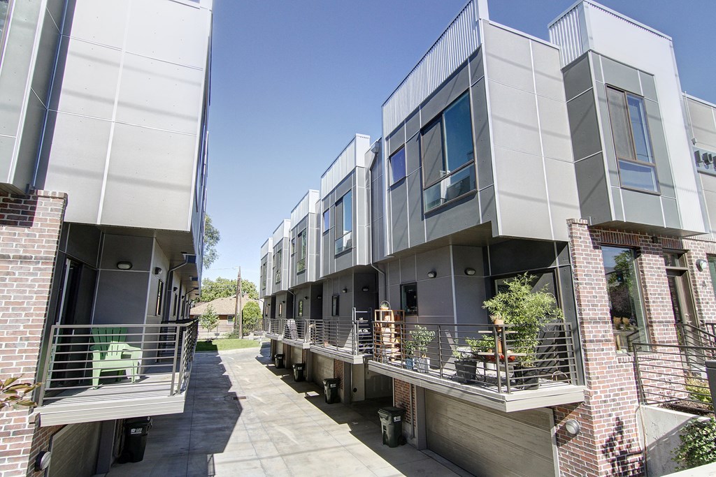 a row of modern apartments with balconies and a sidewalk at BlueKoi Townhomes for rent in Salt Lake City, UT