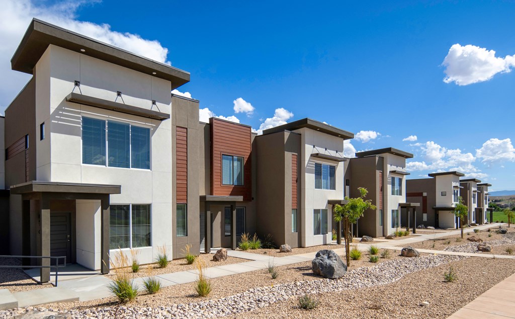 A row of modern houses with brown and beige exteriors.
