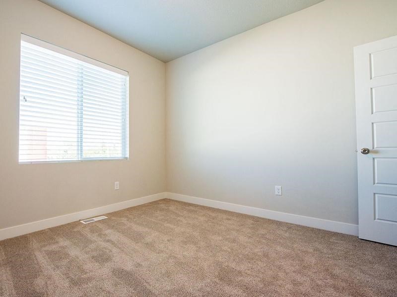 an empty room with a white door and a window