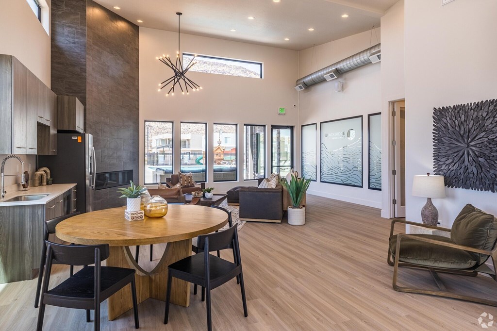 A modern kitchen with a dining table and chairs.