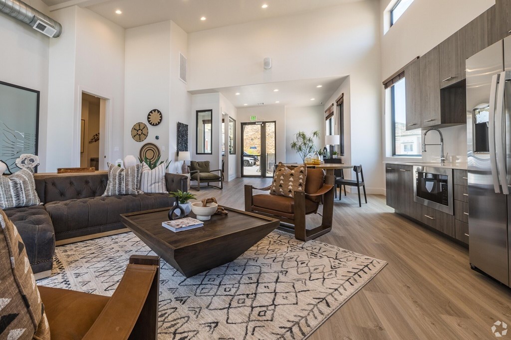 A modern living room with a dark brown sofa and a wooden coffee table.