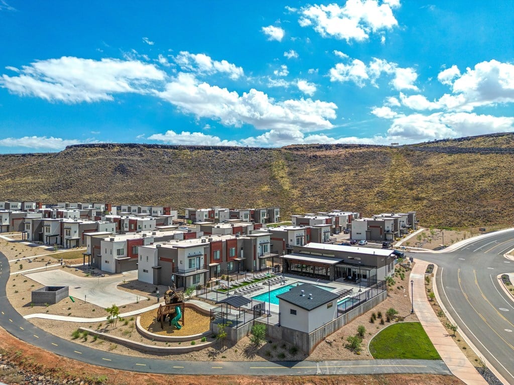 A housing development with a swimming pool and a road.