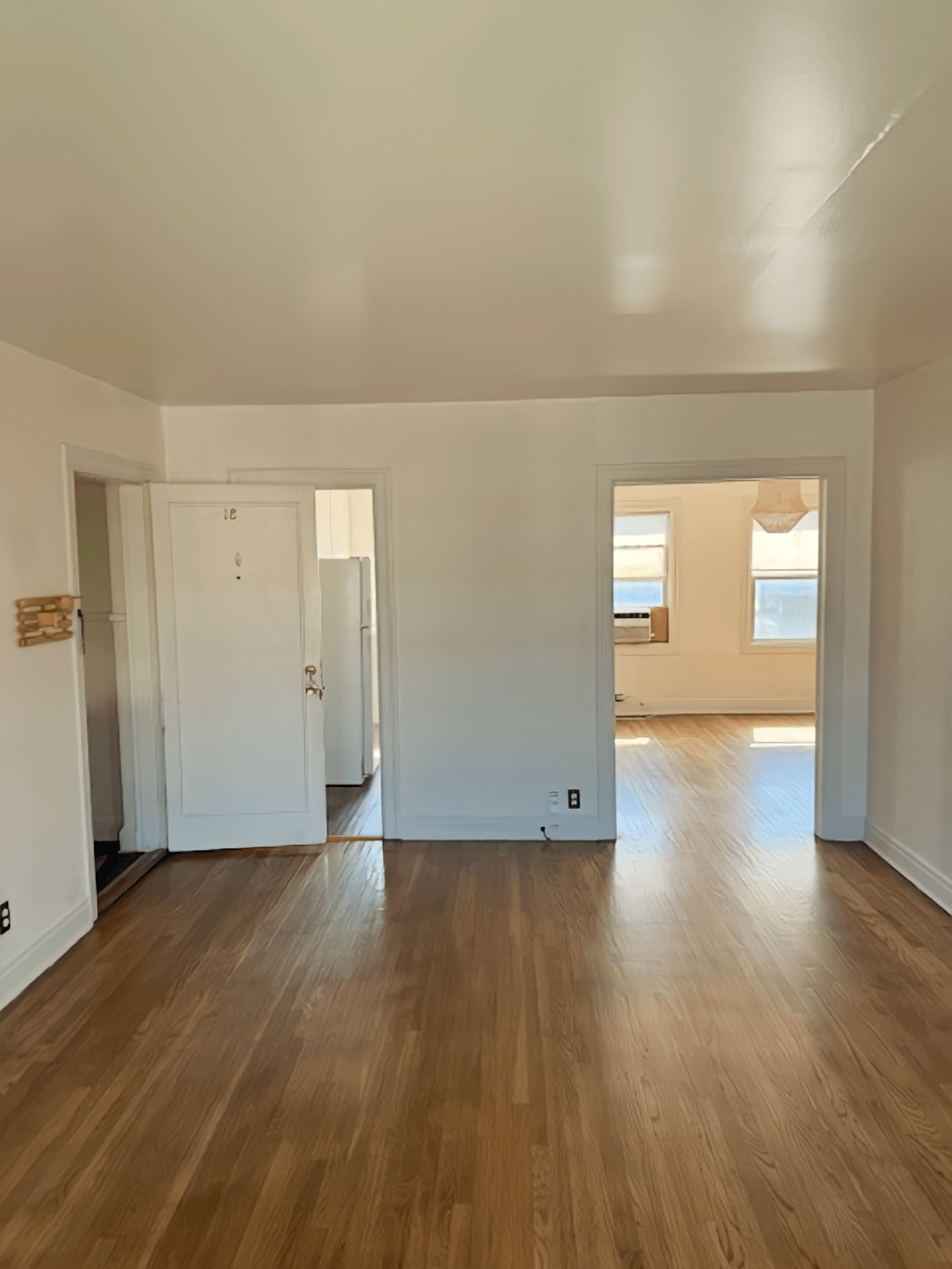 A room with wooden floors and white walls.