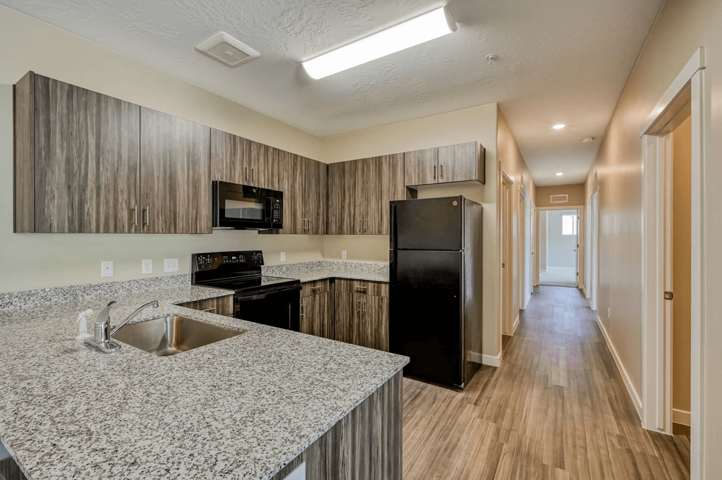 a kitchen with a sink and a refrigerator