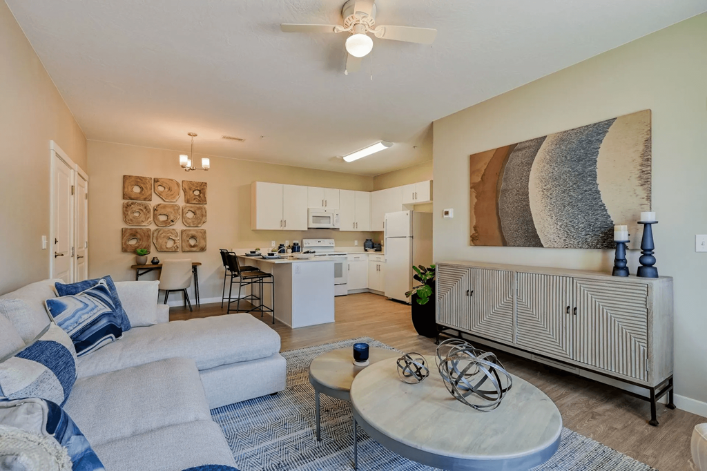 a living room and kitchen with a couch and a table