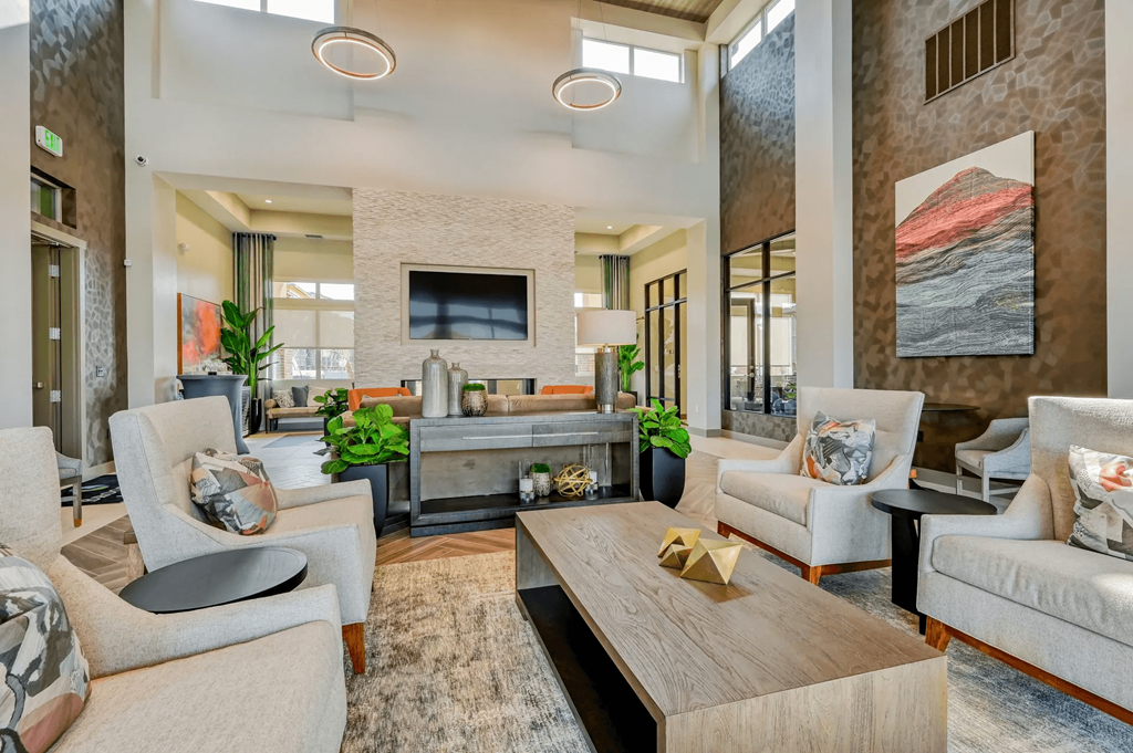 a living room with couches and chairs and a table