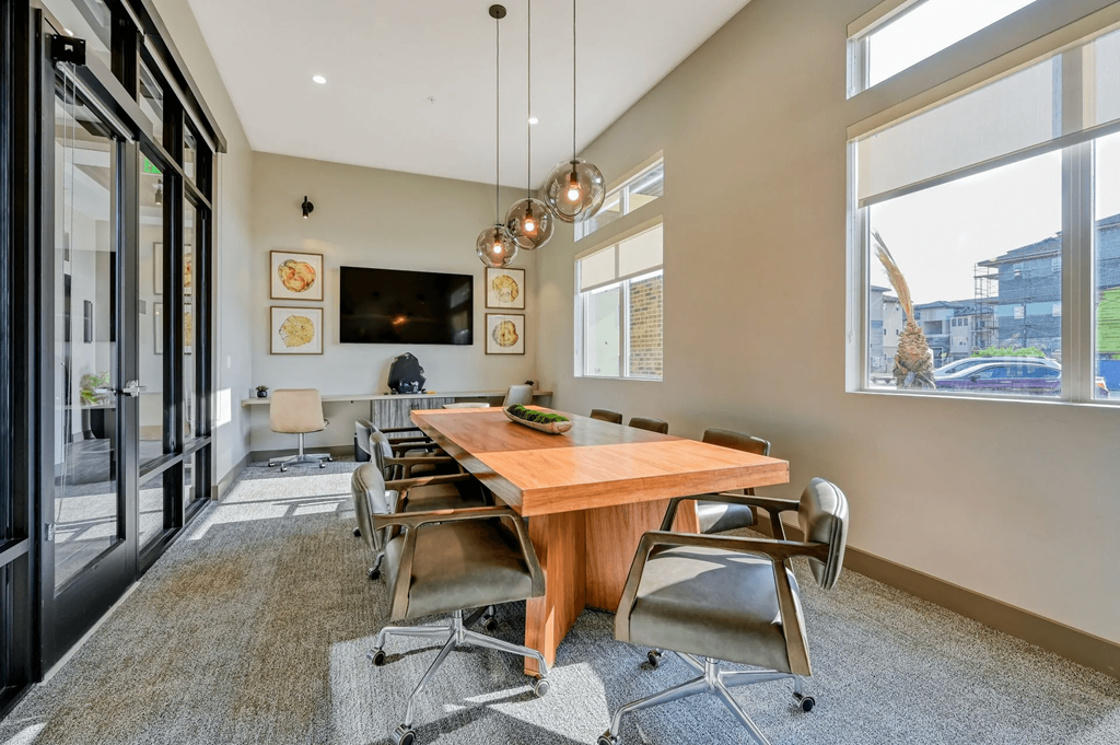 a large conference room with a beautiful wooden table and chairs at Brookfield Apartments for rent in St. George, UT. d