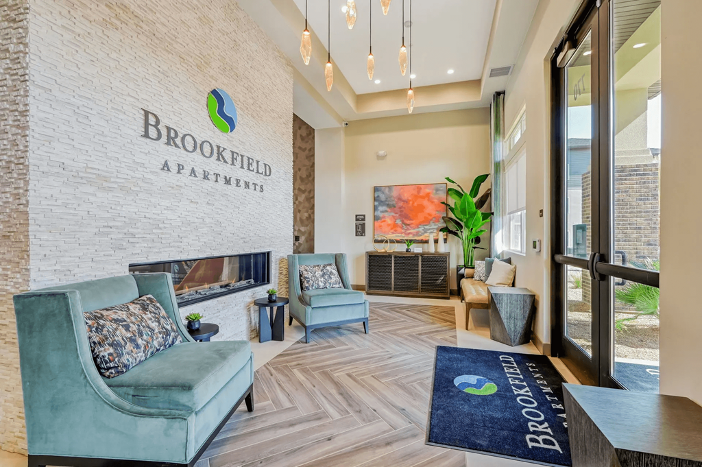 the lobby apartment building with couches and chairs