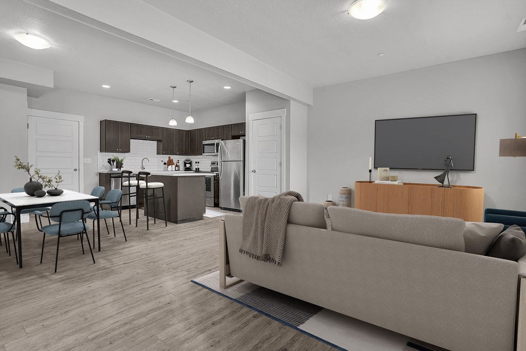 A modern living room with a grey couch and a television.
