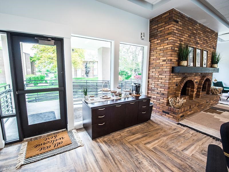 A modern interior with a brick fireplace and a kitchen island.