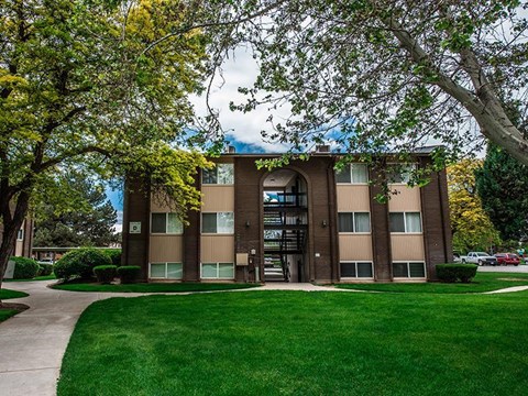 A building with a green lawn in front of it.