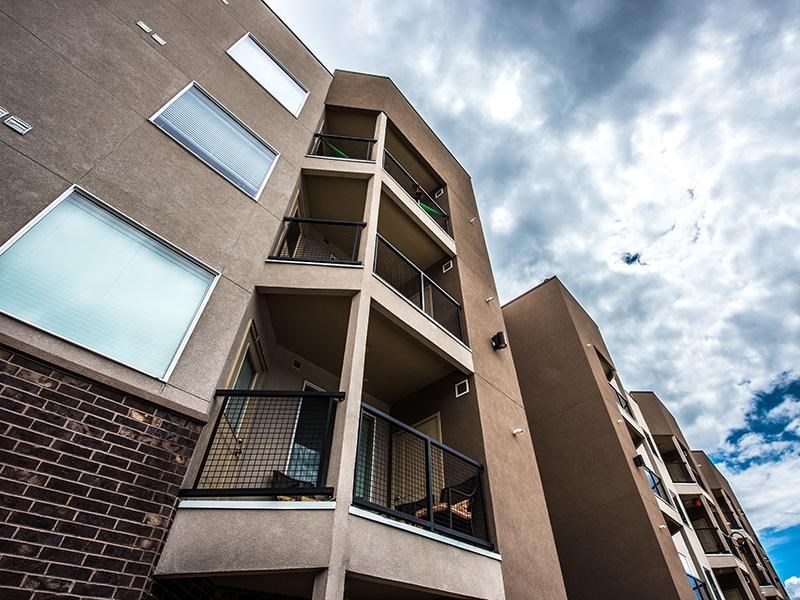 A tall apartment building with balconies and windows.