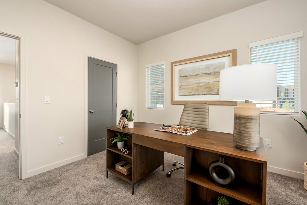 A room with a desk and chair in it.