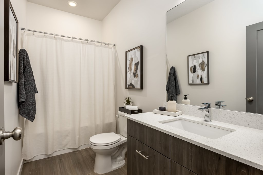 A bathroom with a white toilet and a white sink.