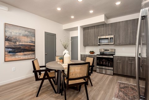 A modern dining room with a table set for two.