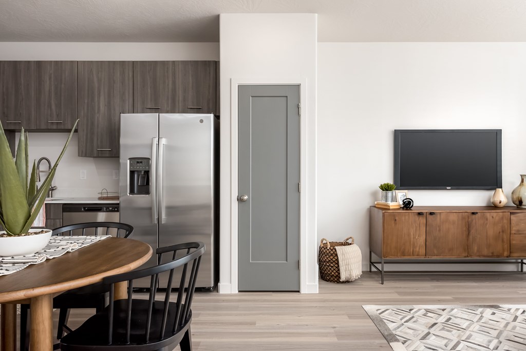 A modern kitchen with a wooden table and chairs.