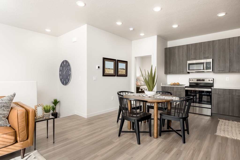A modern kitchen with a dining table and chairs.