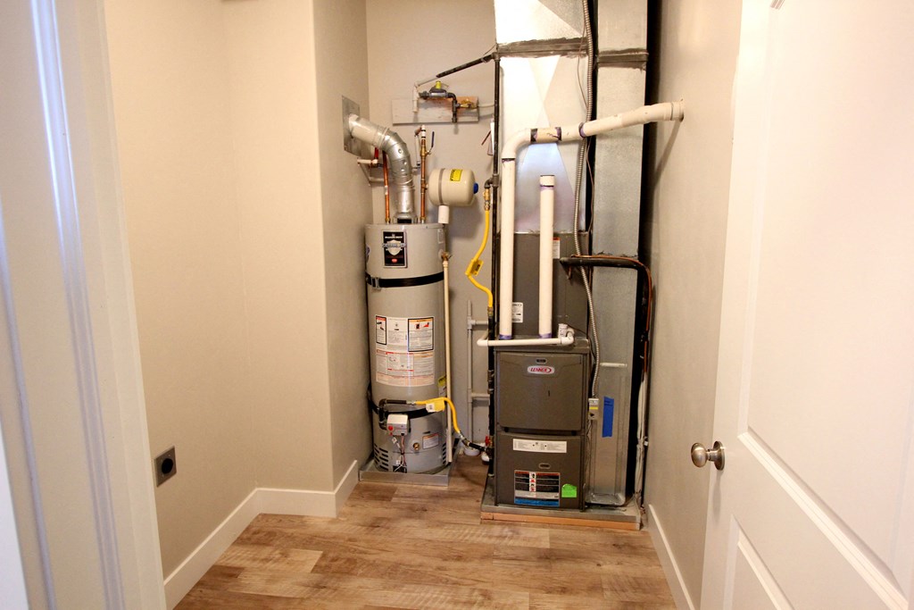 this is a picture of a basement with a water heater and a vacuum cleaner