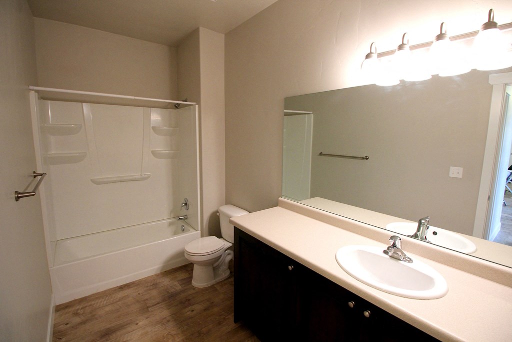 a bathroom with a white toilet next to a white sink