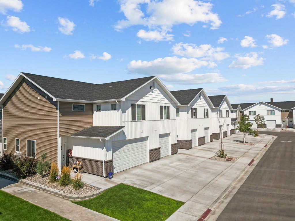 a row of white and brown houses on a street