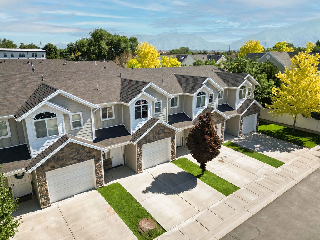 an aerial view of a house with a driveway and garage doors