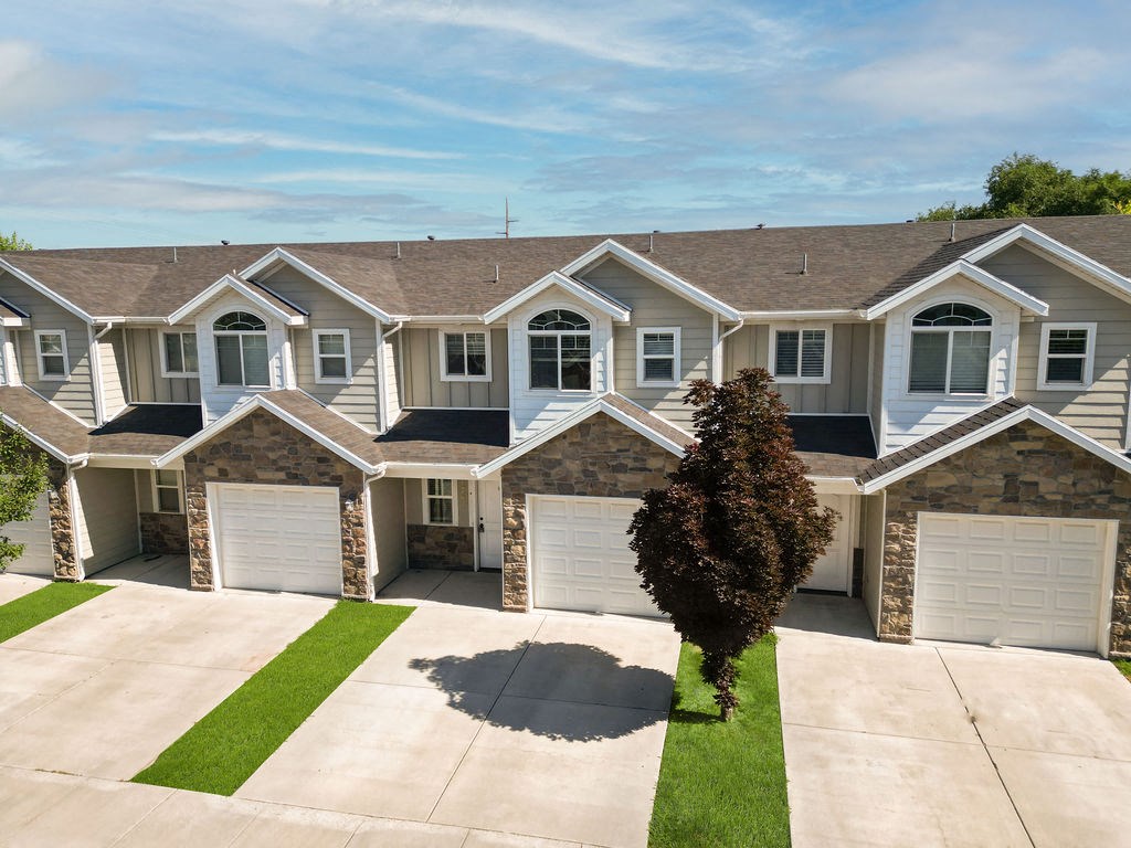 a house with three garage doors on a driveway