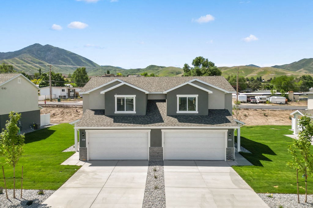 a rendering of a house with a driveway and garage door