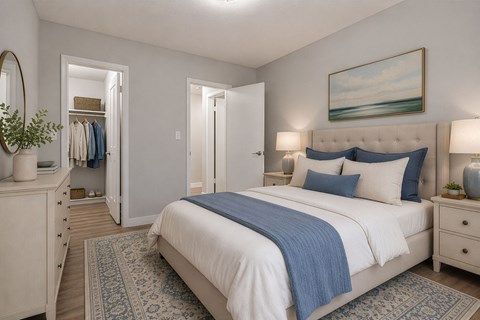 A bedroom with a large bed and a painting of a beach scene on the wall.