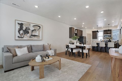 A modern living room with a grey couch and a coffee table.