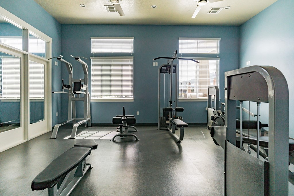 a gym with weights and cable workout equipment at Outlook Apartments in Springville and Provo, Utah