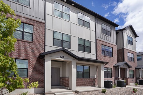 A modern two-story building with a mix of brick and siding exterior.
