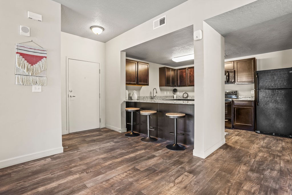 A kitchen with a bar stool and a counter.