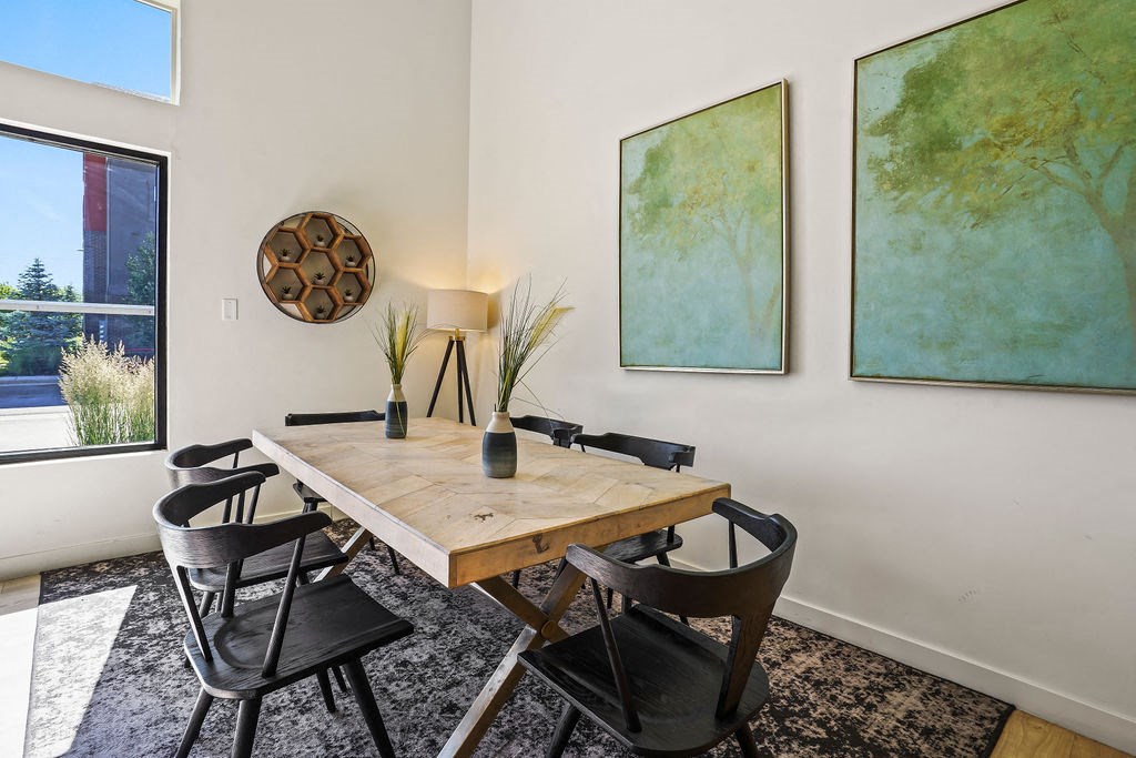 a dining room with a wooden table and chairs