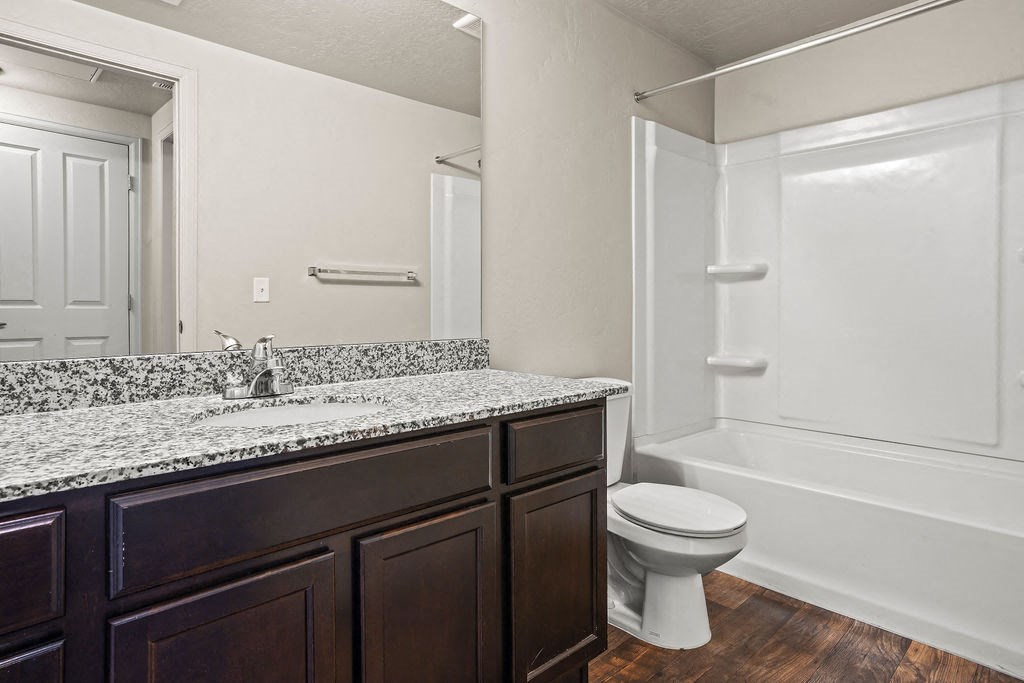 a bathroom with a sink and a toilet and a shower