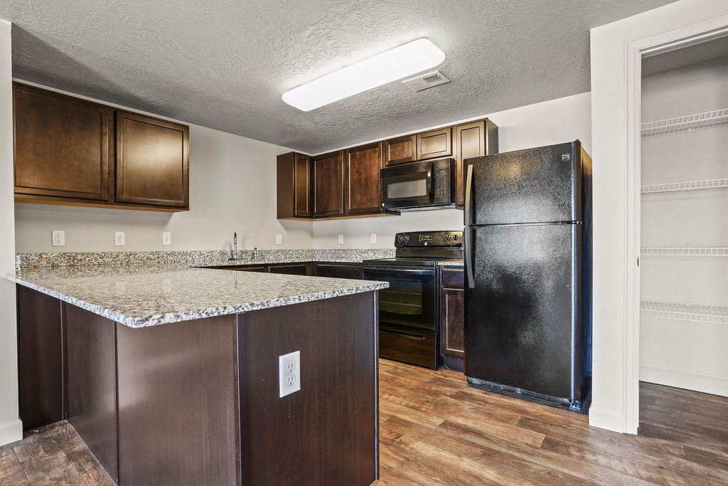 a kitchen with a counter top and a refrigerator