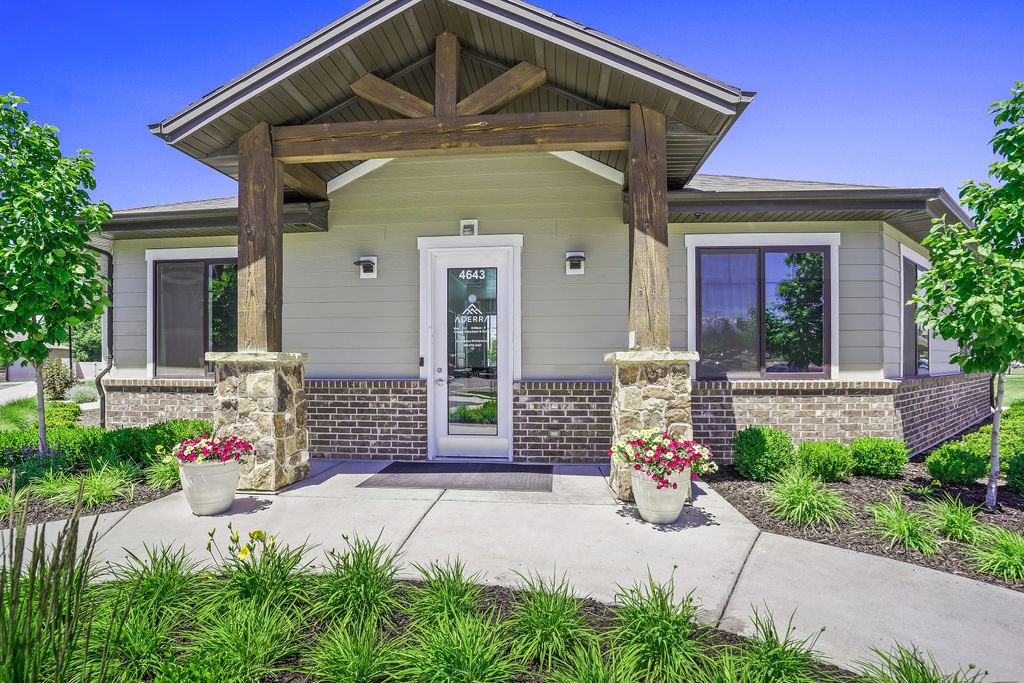 A house with a front porch and a stone pillar.
