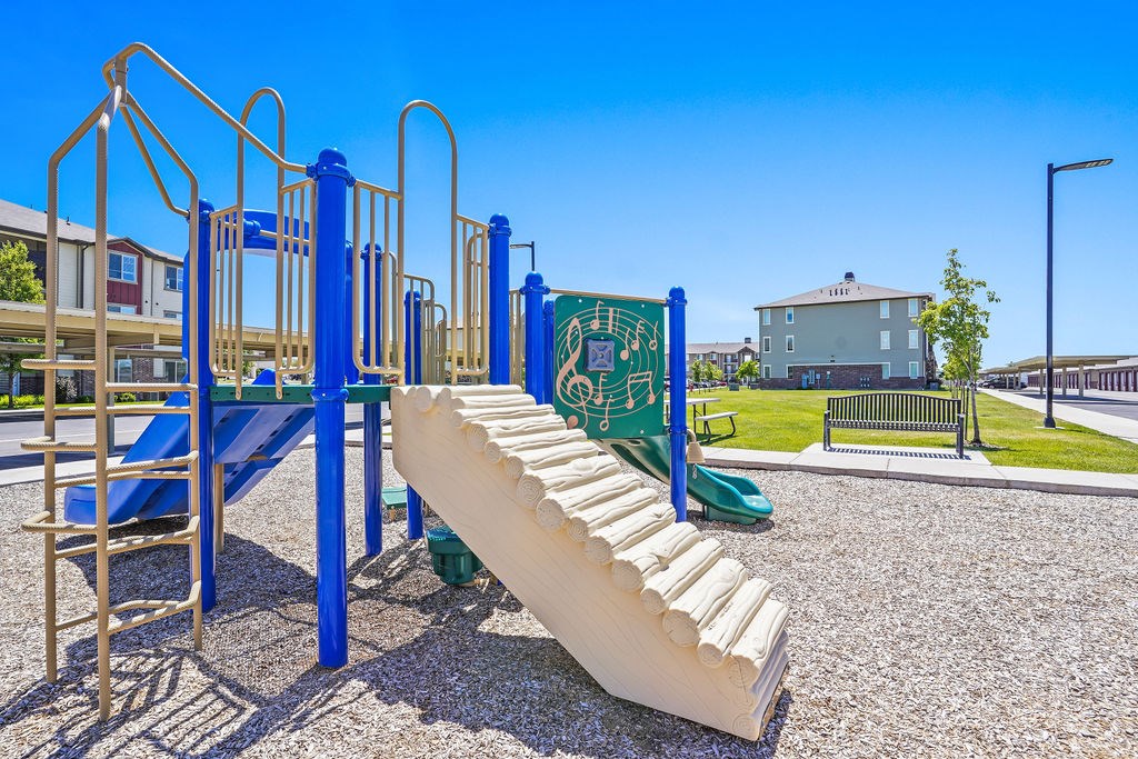 A playground with a slide and swings.