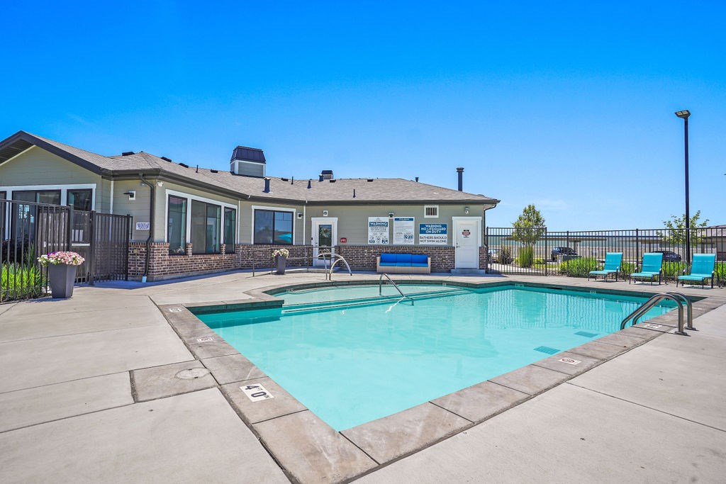 A swimming pool in front of a house.