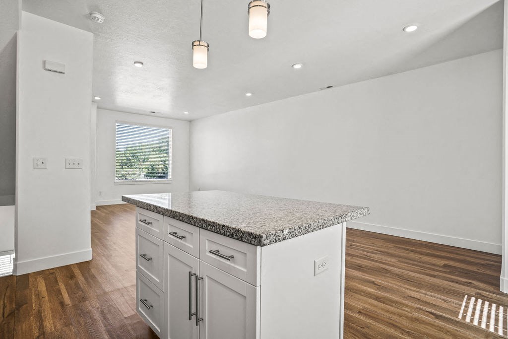a white kitchen with a marble counter top  at Aero Luxury Townhomes in Layton, Utah