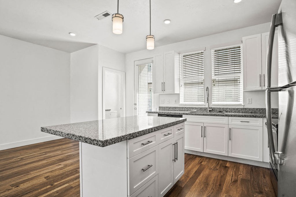 a kitchen with white cabinets and a counter top  at Aero Luxury Townhomes in Layton, Utah