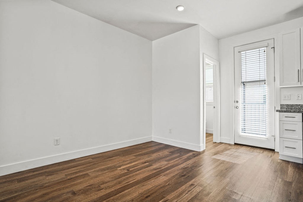 a living room with white walls and wood floors  at Aero Luxury Townhomes in Layton, Utah