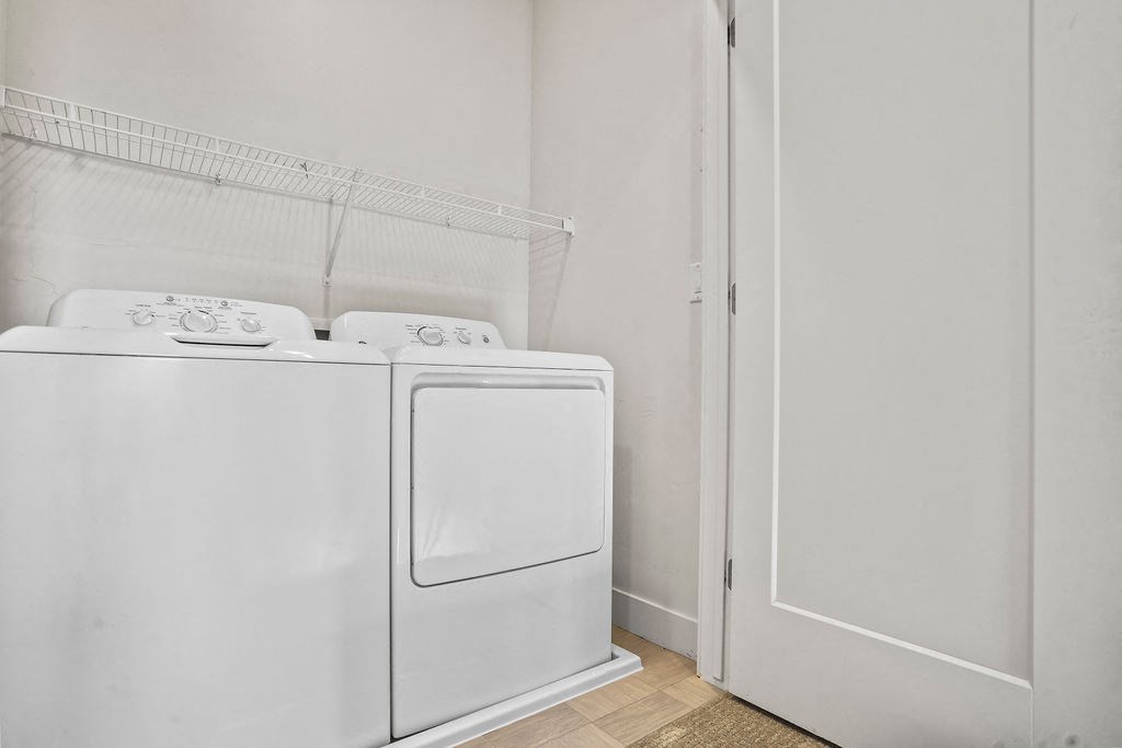 an empty laundry room with a washer and dryer in it  at Aero Luxury Townhomes in Layton, Utah