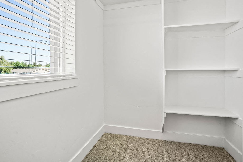 a corner of a room with a window and white shelves  at Aero Luxury Townhomes in Layton, Utah